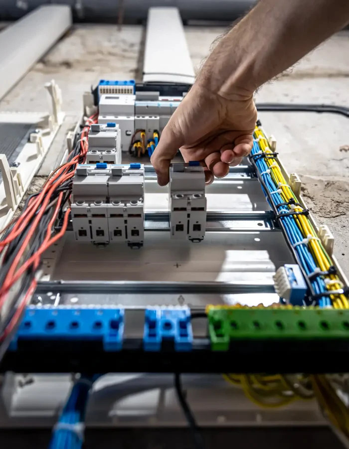 A male hand holding the switch on the electric system.