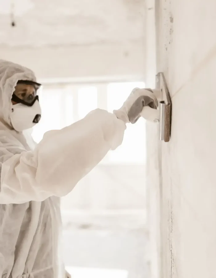 A man covered up while installing a drywall repair.